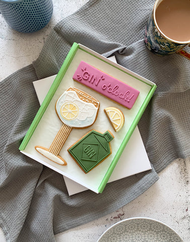 Gin lover glass bottle and lemon iced letterbox biscuits