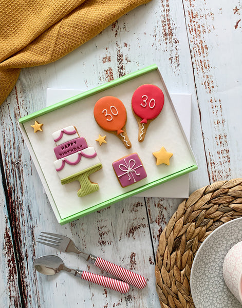 Iced letterbox biscuits featuring birthday cake, birthday present, balloons and star biscuits